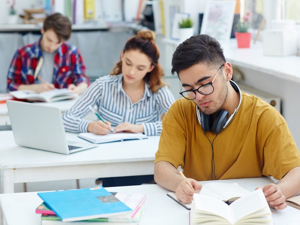 Learners writing essay or test at lesson